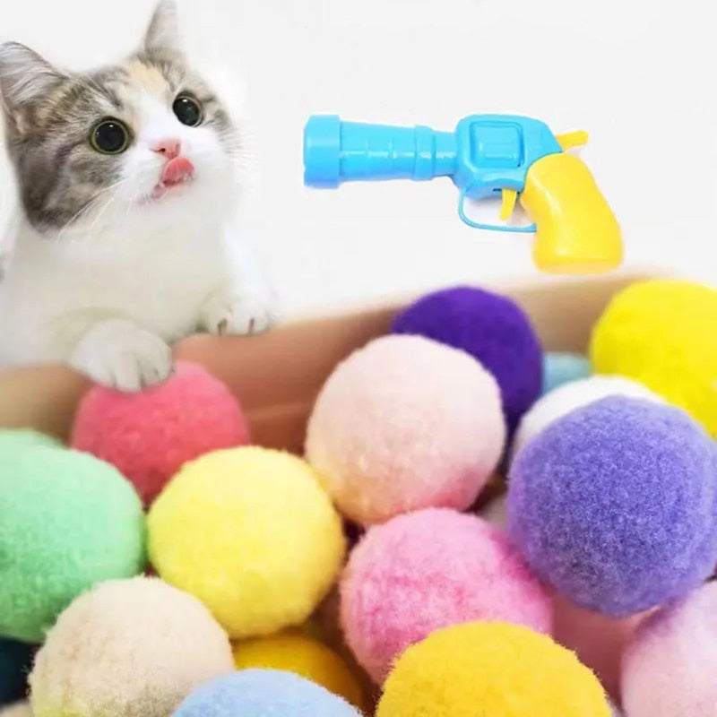 Automatic Ball Launcher toy with colorful soft balls and curious cat nearby for pet play and exercise