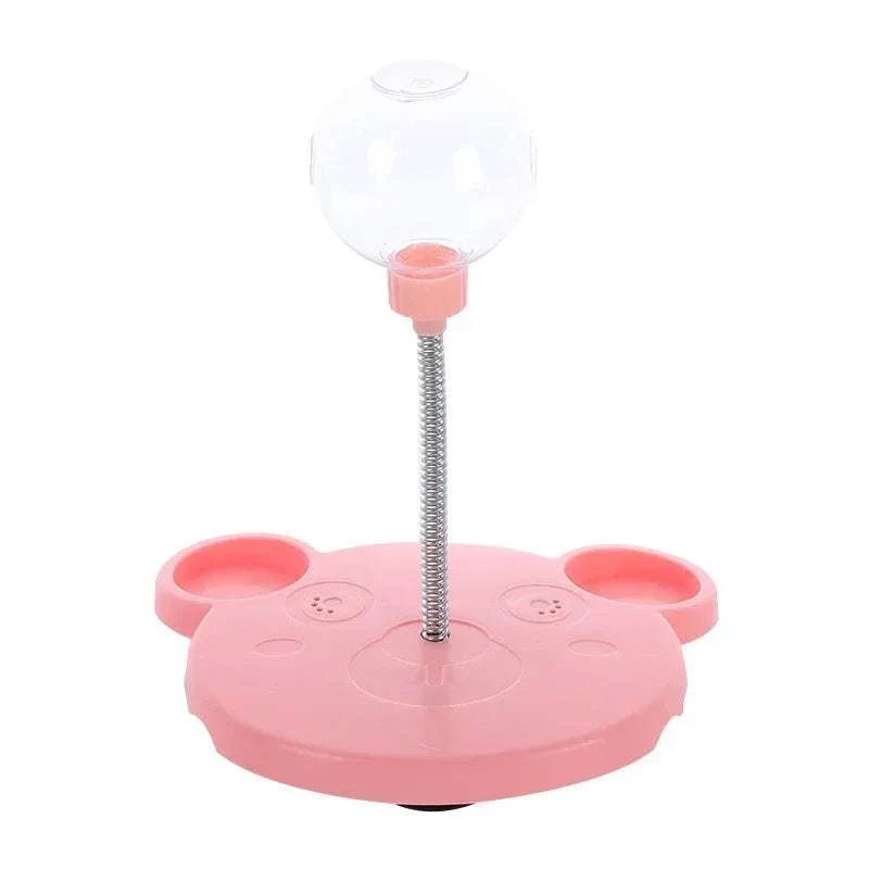 Leaking Treats Ball pet feeder toy with pink base and clear treat ball on spring for interactive pet feeding and play