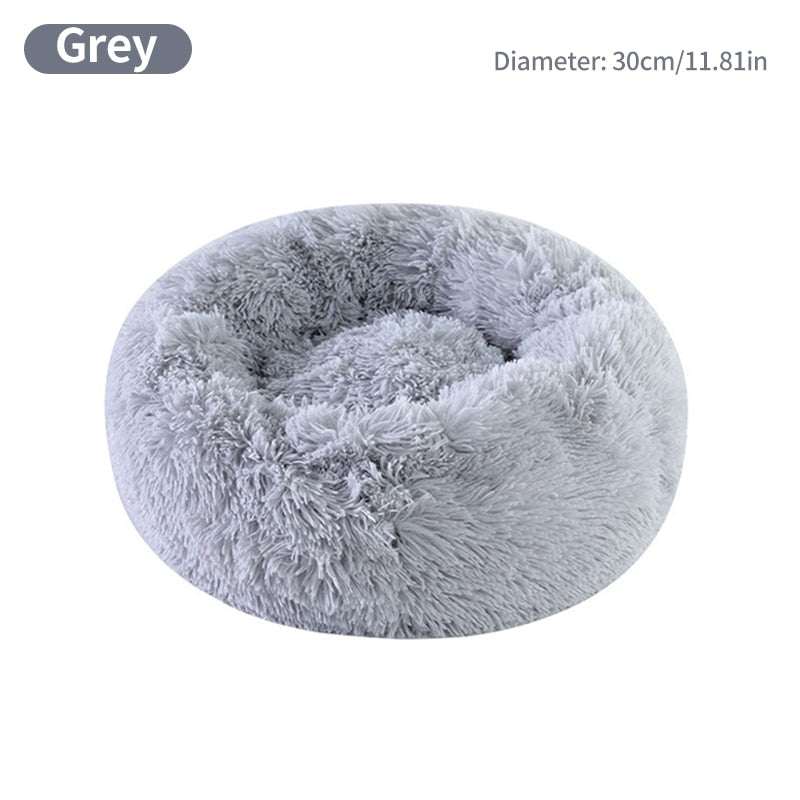 Grey calming pet bed for small dogs with round donut shape and plush bolsters
