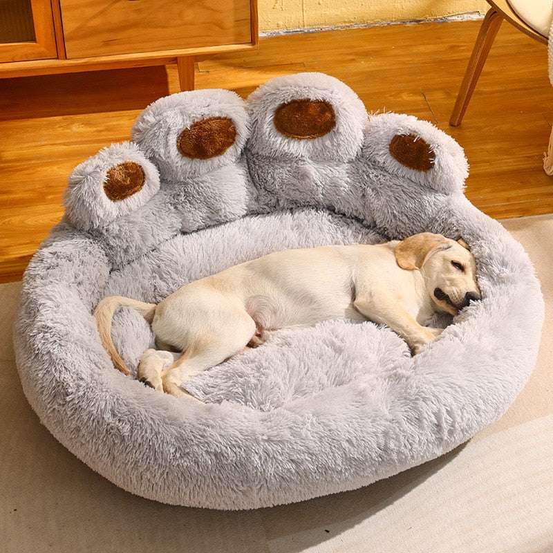 Cute bear paw shaped gray plush pet bed with dog sleeping comfortably inside