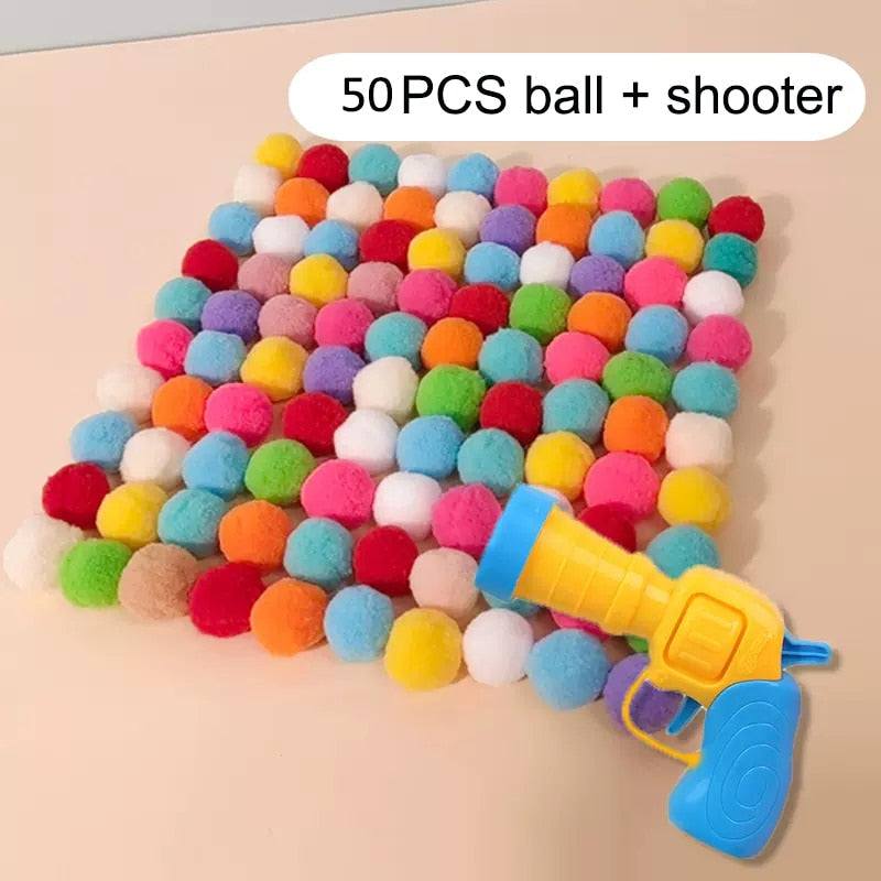 Colorful plush balls with a blue and yellow cat plush silent ball gun toy for interactive play
