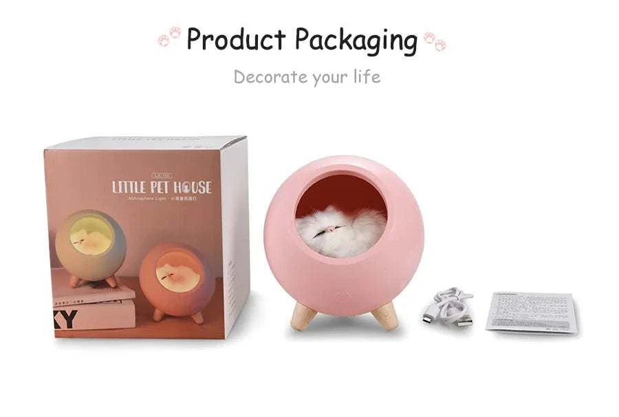 Pink LED cat light with wooden legs, included USB charging cable and instruction manual, displayed next to product packaging box showing two color options.