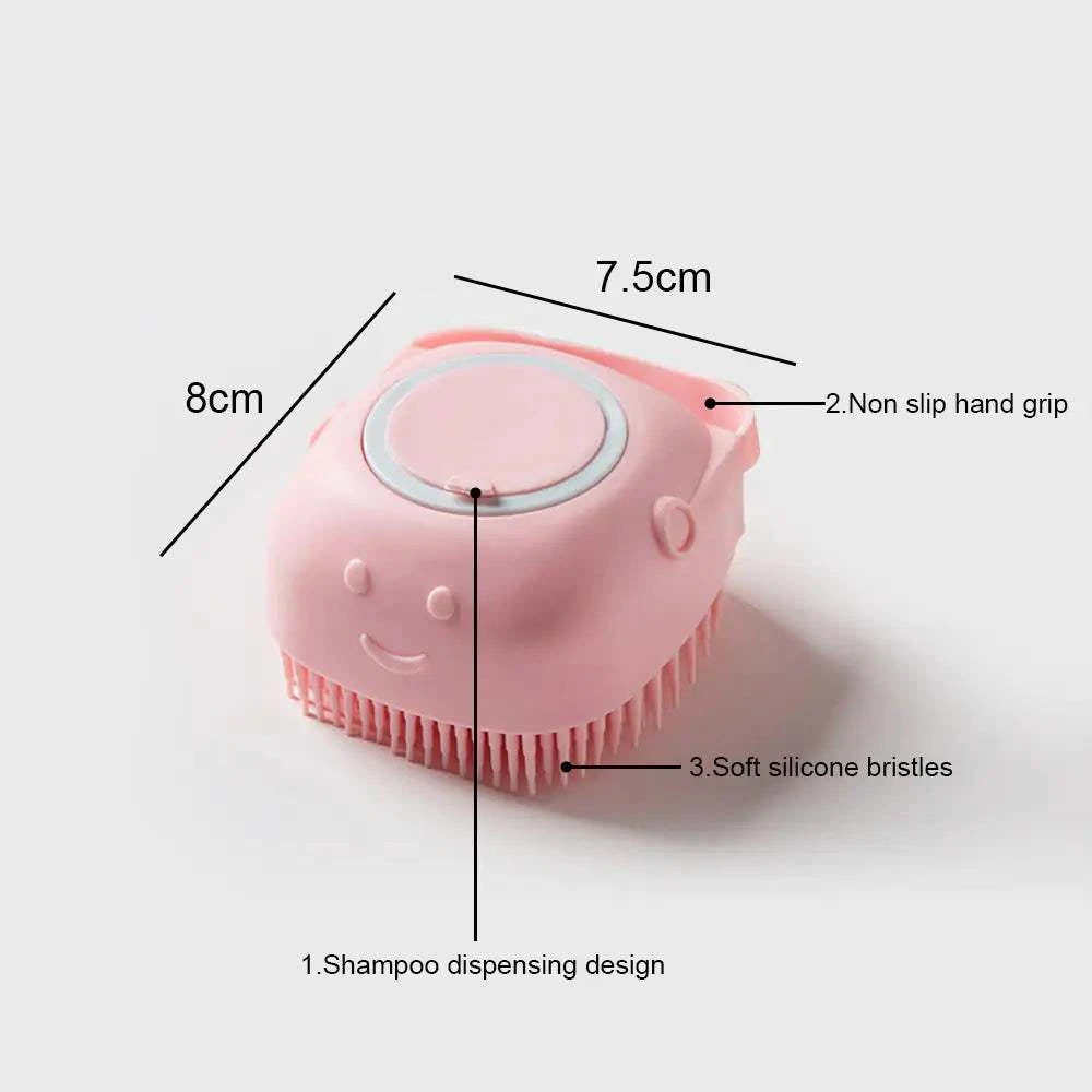 Soft pink silicone dog brush with soft bristles, shampoo dispenser, and non-slip grip for gentle pet grooming.