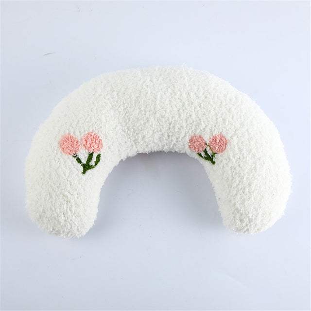 Soft white U-shaped CatCozy pillow with pink flower embroidery for cats' comfort and cervical support