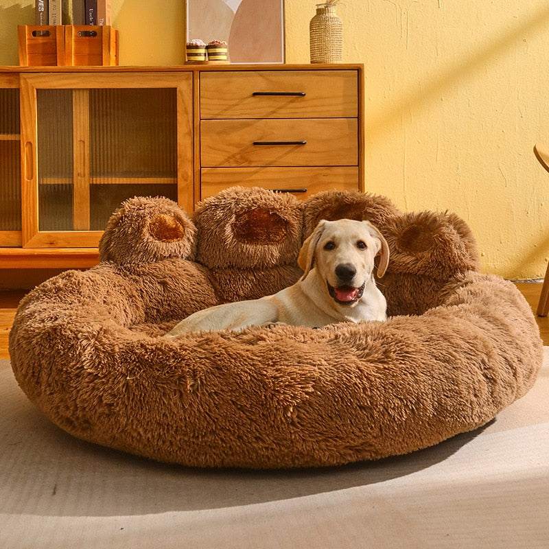 Cute bear paw shaped pet bed with soft plush fabric and a dog resting inside