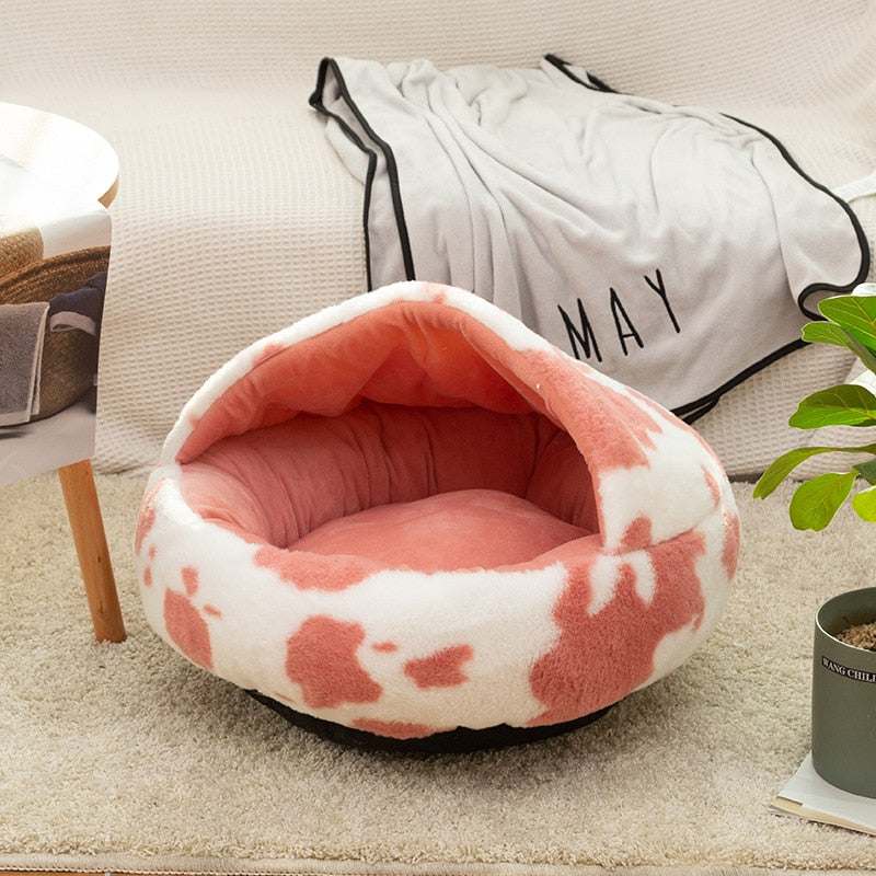 Cozy plush pet cat bed with deep, snug design and non-slip bottom in pink and white pattern