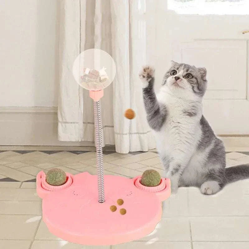 Cat playing with Leaking Treats Ball pet feeder toy dispensing treats on floor