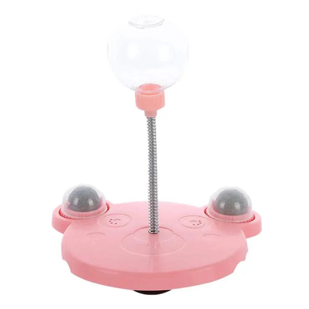 Leaking Treats Ball pet feeder toy with pink base and treat dispenser on spring for mental stimulation