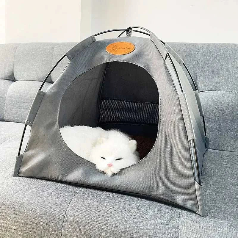 Foldable pet tent with cozy interior and mesh ventilation, shown with white cat inside on grey sofa
