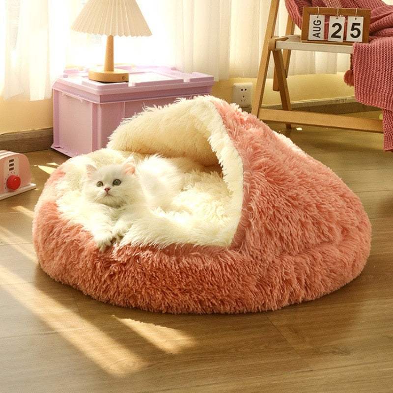 Cute bear paw shape pink and white cozy pet bed with a white cat lounging inside on wooden floor