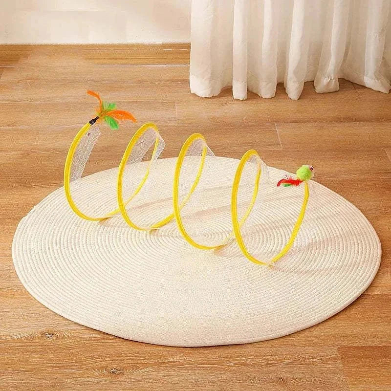 Self-play Cat Hunting Spiral Tunnel Toy with feathers on a round white rug on wooden floor